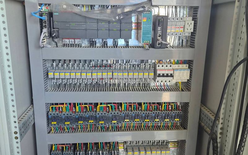 Control panel with a Siemens PLC and expansion modules, power supply, Ethernet switch, relays and contactors